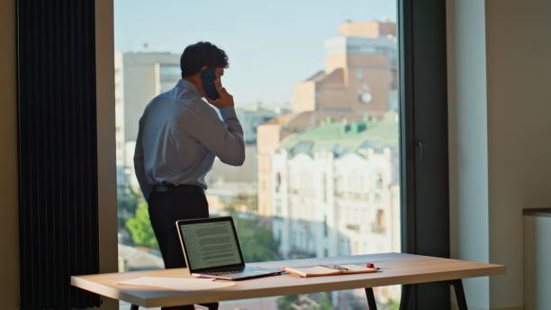 istock Busy manager calling cellphone walking at modern office. Confident businessman 2186847110