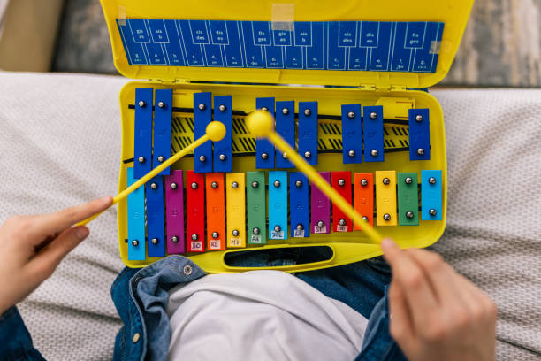 istock Boy plays metallophone at home. 2186847611