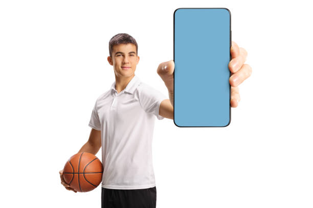 istock Guy holding a basketball and showing a phone screen 2186848110