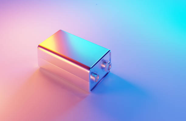Metallic 9 volt battery illuminated by blue and magenta lights on blue and magenta background. Horizontal composition. Simple battery concept.