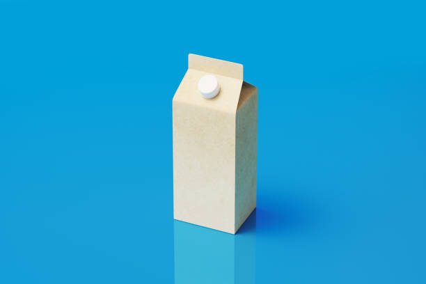 Milk package made of recycled paper on blue background. Horizontal composition. High angle view.