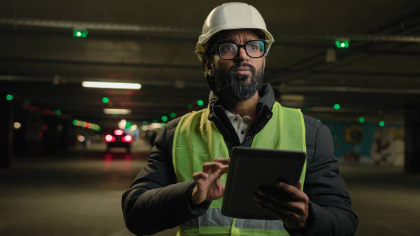 Foreman inspecting parking lot underground urban industrial heavy industry engineer Arabian man Indian builder in hard hat architect manufacture worker digital tablet talking video call conference Foreman inspecting parking lot underground urban industrial heavy industry engineer Arabian man Indian builder in hard hat architect manufacture worker digital tablet talking video call conference. High quality 4k footage digital underground stock pictures, royalty-free photos & images