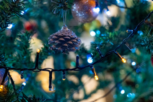 istock Holiday decorations feature pine cone and sparkling lights on a Christmas tree in a cozy living room during the festive season 2186852443