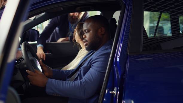 istock Husband and wife purchasing new vehicle, evaluating how it feels 2186852827