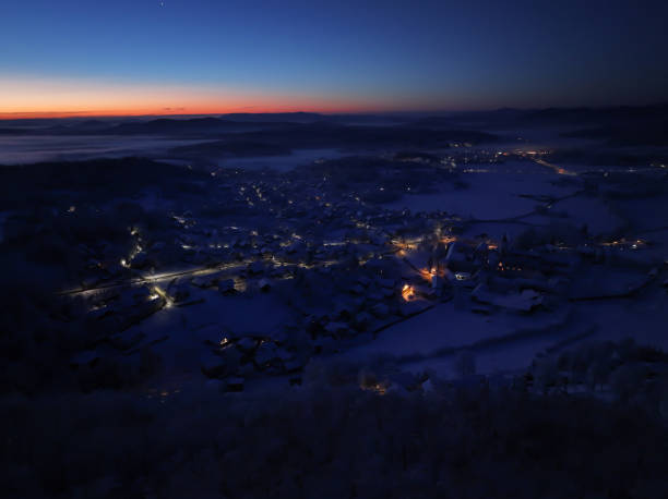 istock AERIAL: Small village covered with fresh fallen snow under soft light of dusk 2186853009
