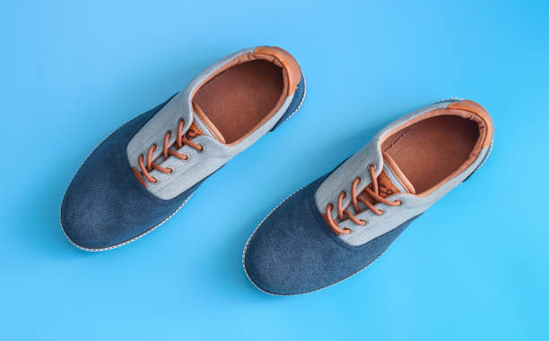 istock Denim male sneakers on a blue background. 2186854132