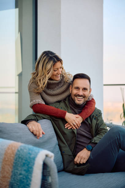 istock Happy couple relaxing on a balcony in autumn. 2186856022