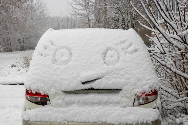 istock Winter fun. A car covered with snow has eyes with eyelashes painted on the snow 2186856374