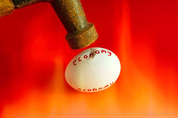 Stress on the economy. Concept of the economy under stress from overheating and powerful forces from above. A hammer cracking an overheated egg with room for copy.