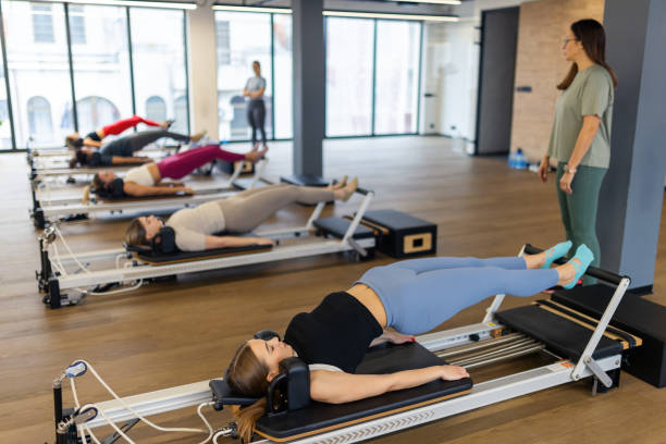 istock Women of different age doing exercises on pilates machines 2186858017