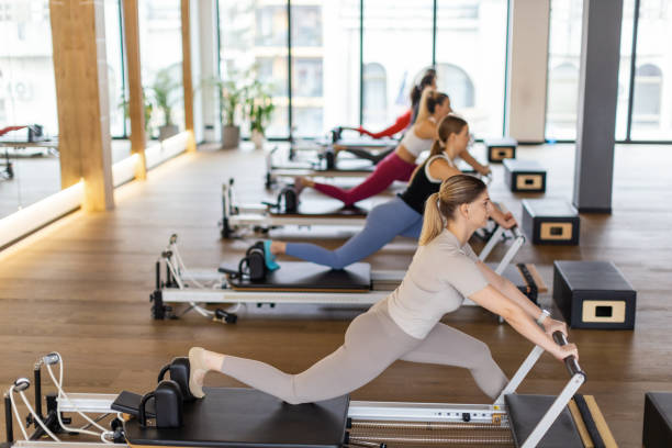 istock Women of different age doing exercises on pilates machines 2186858132