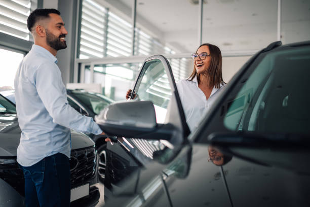 istock Customer explores interior features of vehicle at dealership. 2186859073