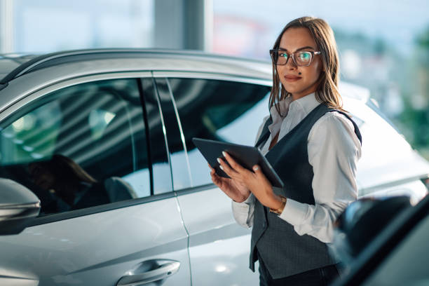 istock Focused woman using a tablet for car evaluation in dealership 2186859113