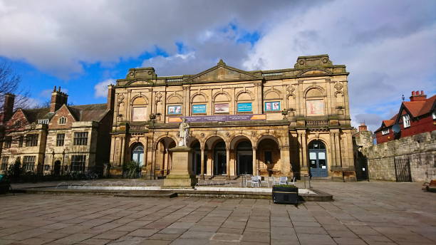 York, UK - 3.17.2018: Exhibition Square with a statue of William Etty in front of the facade of York Art Gallery under a cloudy blue sky before the pandemic in the winter without pedestrians