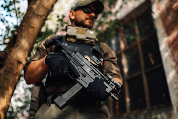 istock Soldier holding a submachine gun in war zone 2186860682