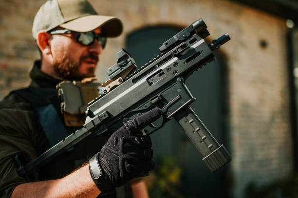 istock Soldier holding a modern submachine gun during a military operation 2186860722