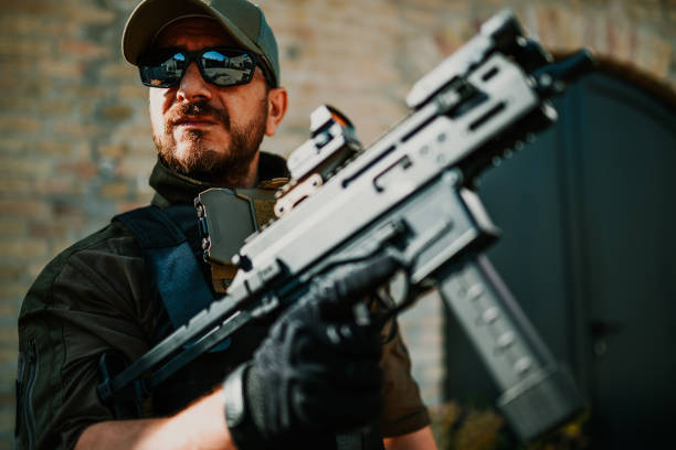 istock Soldier holding a submachine gun in urban warfare 2186860733