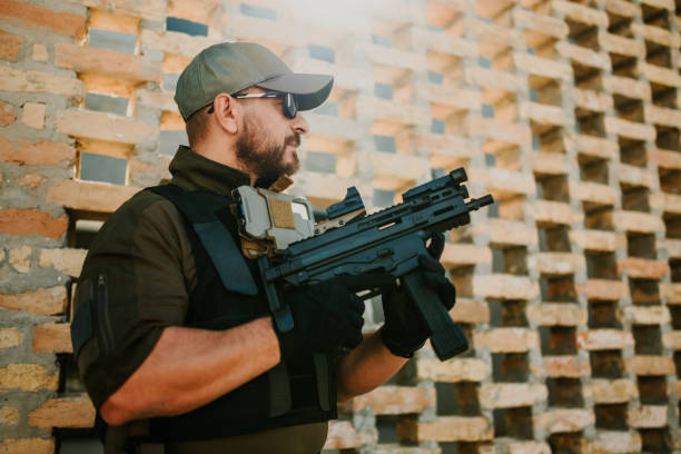 istock Soldier holding a rifle and looking away from the camera 2186860740