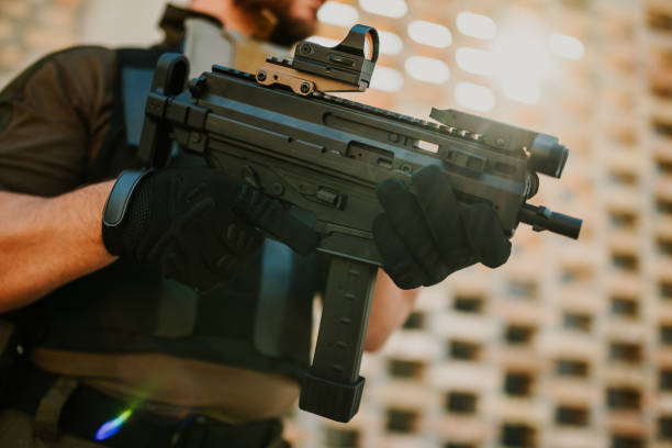 istock Soldier holding a submachine gun with a red dot sight 2186860750