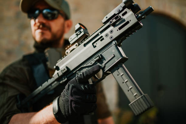 istock Soldier holding a submachine gun with red dot sight 2186860752