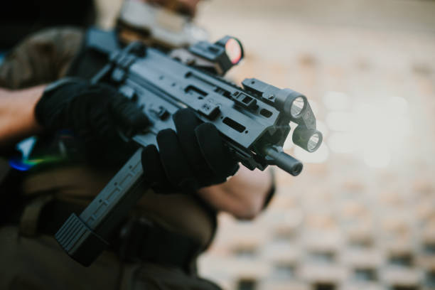 istock Soldier holding a modern assault rifle with tactical accessories 2186860759