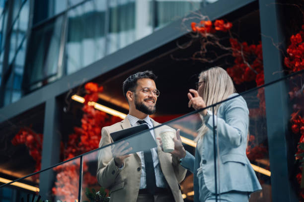Business colleagues discussing work on office balcony