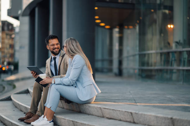 istock Business colleagues discussing work on tablet outdoors 2186861488