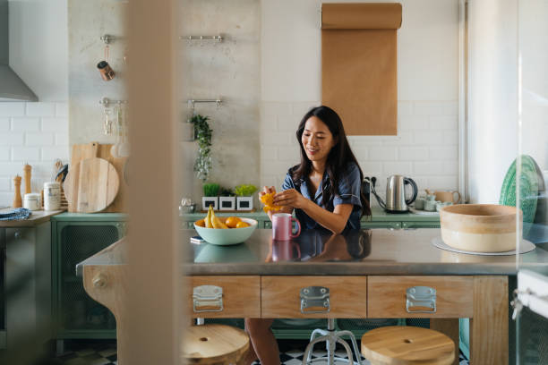 istock Japanese woman having her fruit breakfast in the kitchen 2186861541