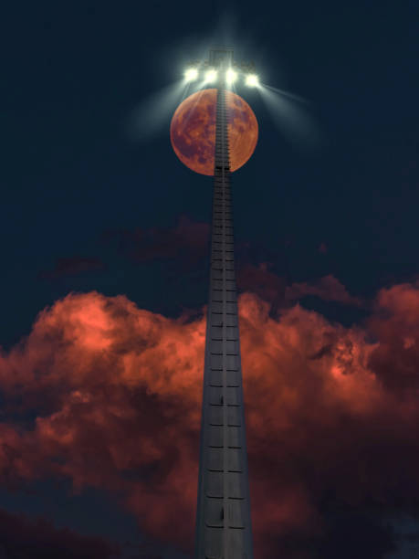 istock Large red moon rising behind a stadium light pole at night 2186862239