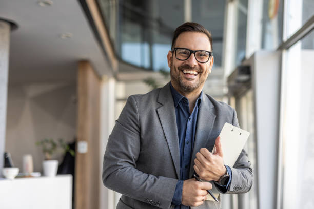 istock Smiling handsome businessman in corporate setting 2186863130
