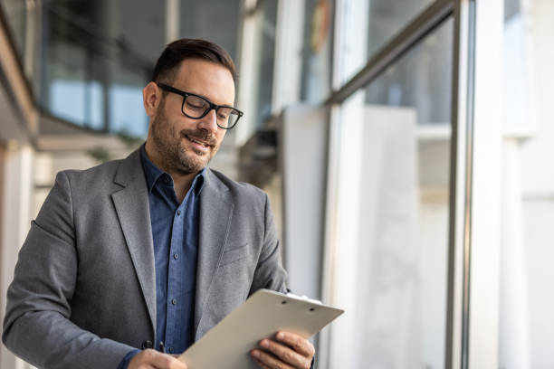 istock Smiling handsome businessman in corporate setting 2186863131