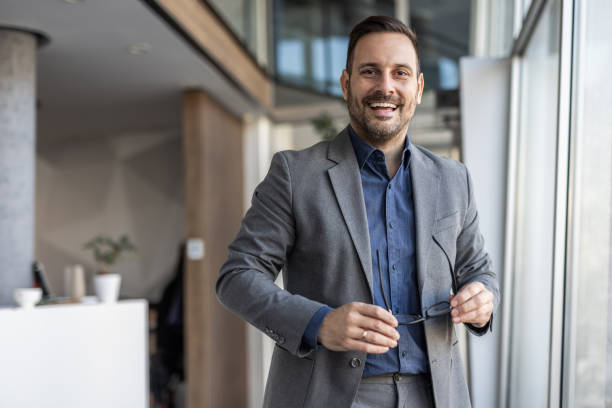 istock Smiling handsome businessman in corporate setting 2186863137