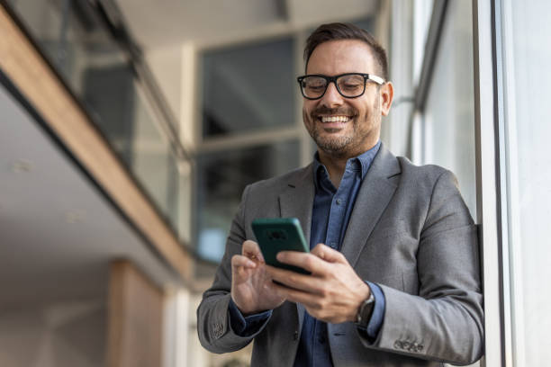 istock A businessman with style - the phone as a tool, a smile as an attitude 2186863164