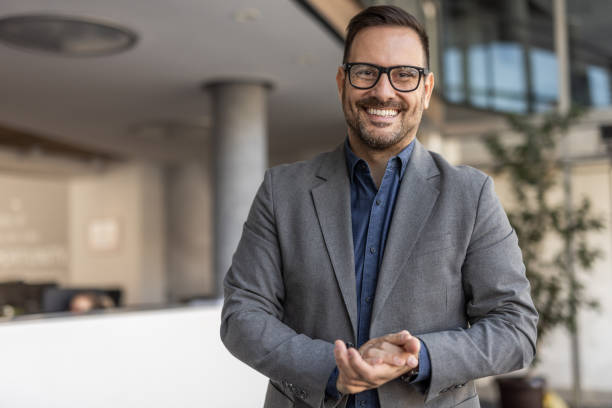 istock Smiling handsome businessman in corporate setting 2186863168