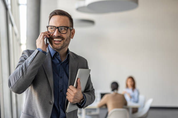 istock Confident middle-aged businessman in the office, focused on an important phone conversation 2186863183