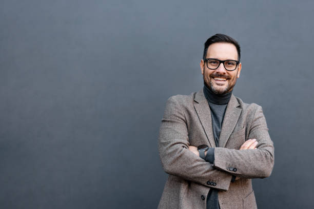 istock Confident man in blazer and turtleneck with folded arms stance. 2186864047
