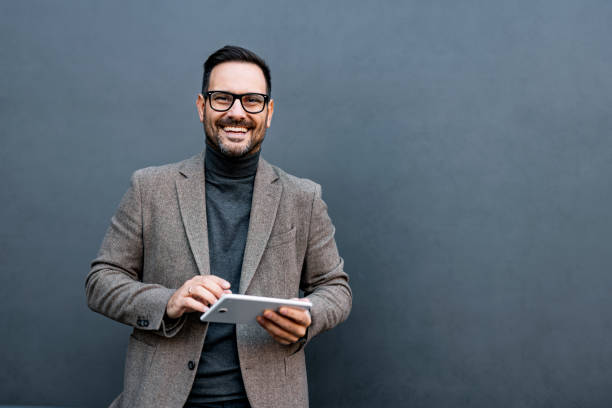 istock Man smiling with tablet in hand, modern digital engagement. 2186864097
