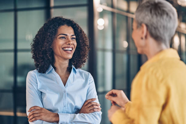 istock Two beautiful businesswomen talking 2186864759