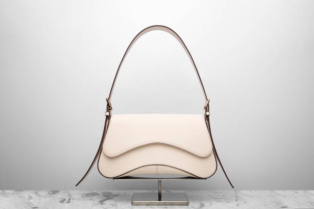 istock Luxury women's bag on a white background. Light cream color 2186865359
