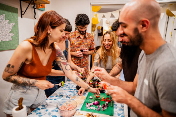 istock Friends preparing food at domestic kitchen 2186866926