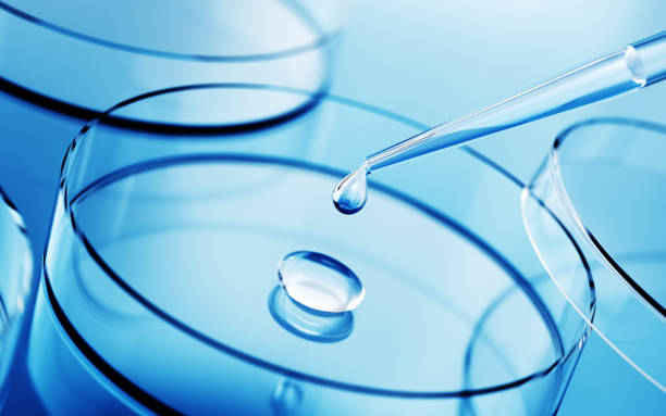 istock Testing Liquid from Glass Pipette into Petri Dish on Blue Reflective Background 2186867569