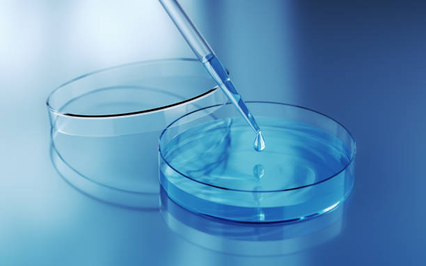 istock Testing Liquid from Glass Pipette into Petri Dish on Blue Reflective Background 2186867573