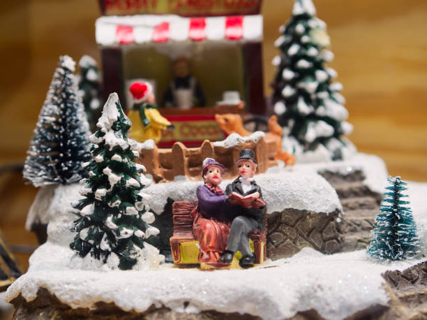 istock Miniature Christmas scene couple on a bench 2186867677