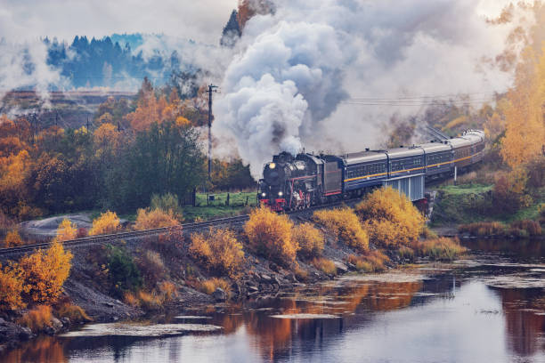 istock Retro steam train moves along the lake. 2186869426