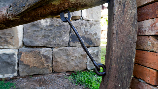 Close-up of an old iron chain securing a stone post in an urban street in the historic center of León, outside Plaza San Isidoro. Urban squares and streets in the center of León in autumn. León, Castile and León, Spain - September 22, 2024.