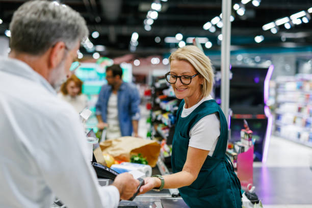 istock Senior customer paying with contactless technology at supermarket checkout 2186871925