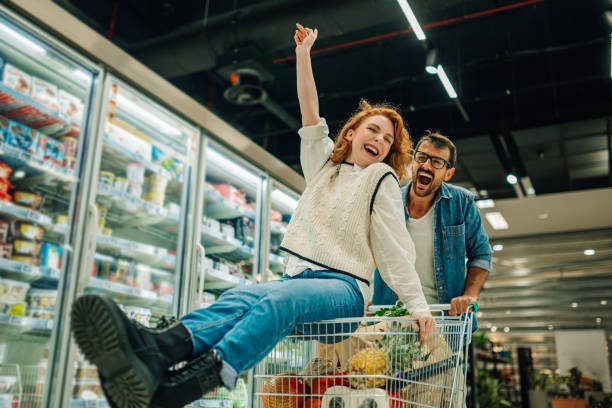 istock Couple having fun while grocery shopping in supermarket 2186872029