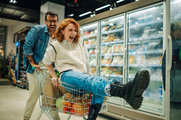 istock Couple having fun while shopping groceries in supermarket 2186872038