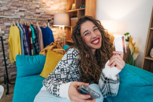 istock A cheerful 21-year-old student is sitting on the sofa in her living room. 2186874009