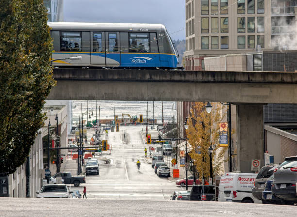 Downtown Vancouver, British Columbia, Canada - November 29, 2018: Skytrain passing in the modern city during a cloudy evening.